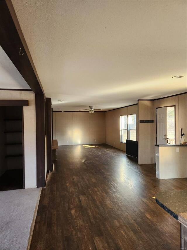 15005 Carthage Rd, Dixon, MO 65459 - unfurnished living room with a ceiling fan, dark wood-style floors, and a textured ceiling