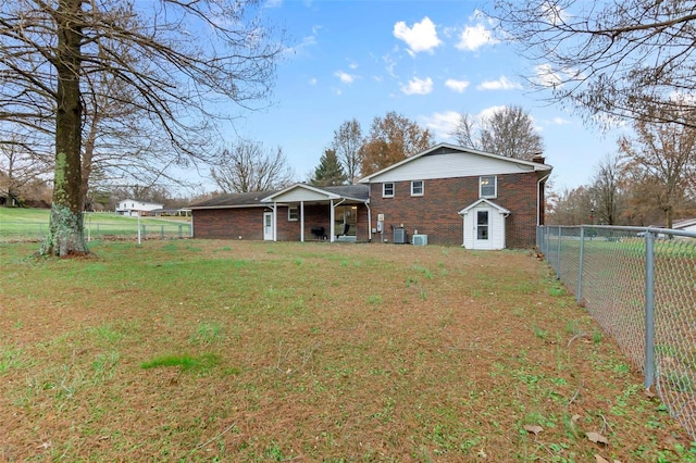 back of house with brick siding and a chimney