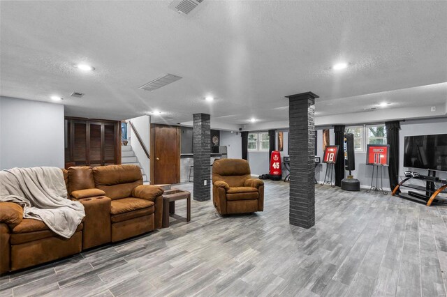 building lobby with a textured ceiling, recessed lighting, and stairway