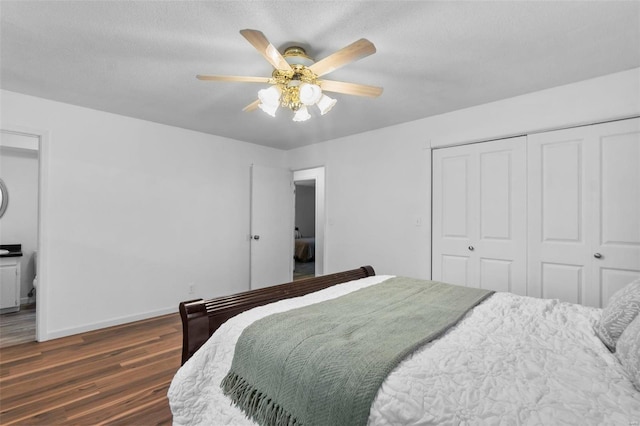bedroom with wood finished floors, a closet, baseboards, and ceiling fan