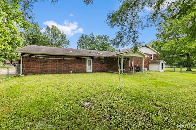 70 Garnet Ln, Cape Girardeau, MO 63701 - back of property featuring brick siding, a fenced backyard, and a storage unit