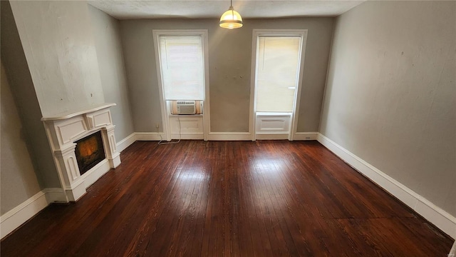 1412 Benton St, Saint Louis, MO 63106 - unfurnished living room with dark wood finished floors, cooling unit, a lit fireplace, and baseboards