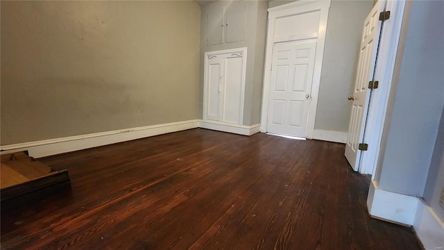 1412 Benton St, Saint Louis, MO 63106 - empty room featuring dark wood-style floors and baseboards
