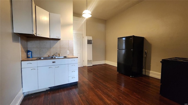 1412 Benton St, Saint Louis, MO 63106 - kitchen featuring freestanding refrigerator, a sink, dark wood finished floors, baseboards, and decorative backsplash