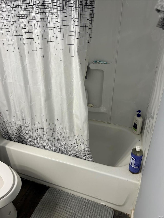 3408 Airway Ave, Saint Louis, MO 63114 - bathroom with shower / bath combo with shower curtain, toilet, and wood finished floors