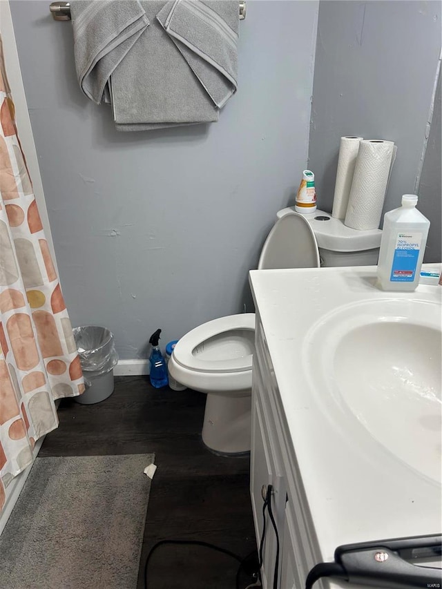 3408 Airway Ave, Saint Louis, MO 63114 - full bath featuring wood finished floors, toilet, curtained shower, baseboards, and vanity