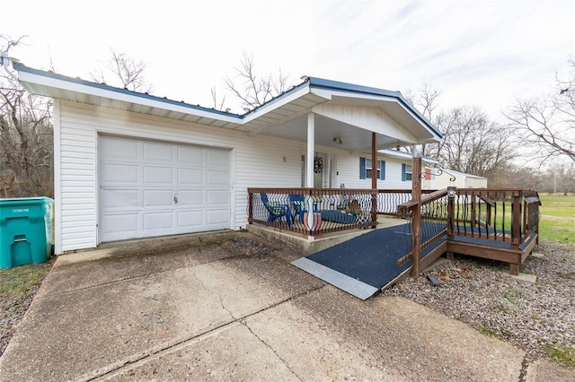view of front of home with concrete driveway, a porch, and a garage