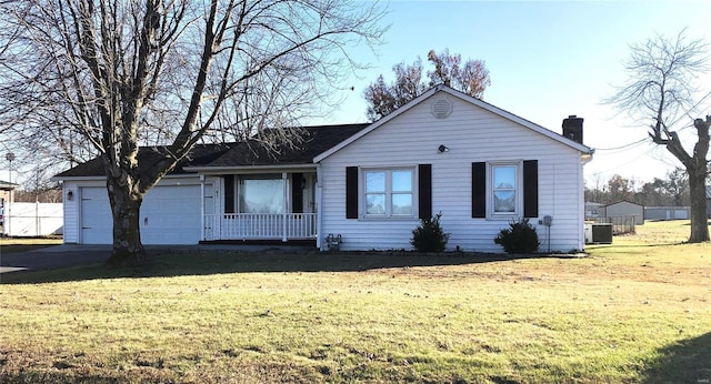 view of front of home featuring a front yard, a chimney, and covered porch