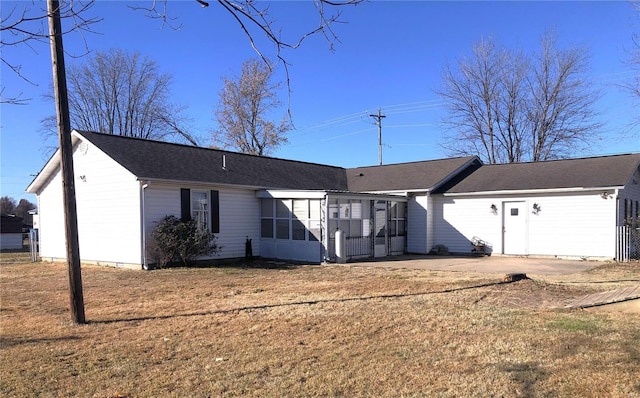 back of property with a sunroom