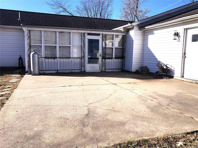 back of property with roof with shingles