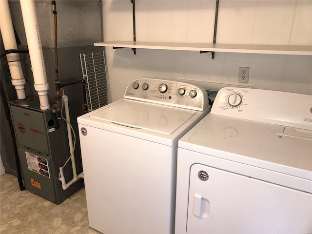 laundry room featuring separate washer and dryer and heating unit