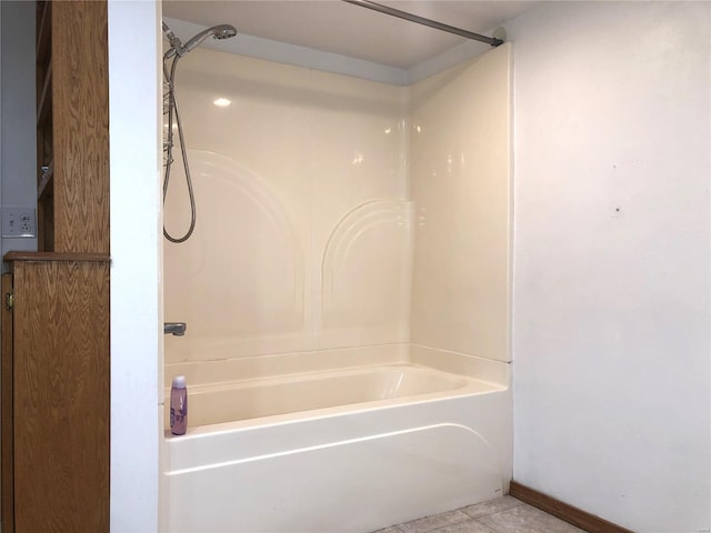 full bath with washtub / shower combination and tile patterned flooring