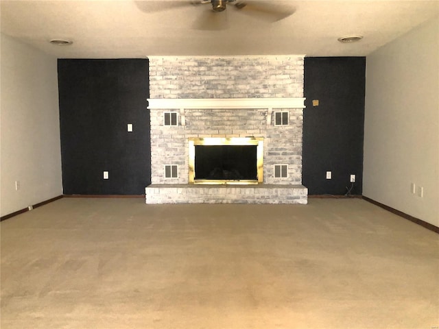 unfurnished living room with a ceiling fan, carpet floors, a fireplace, and baseboards
