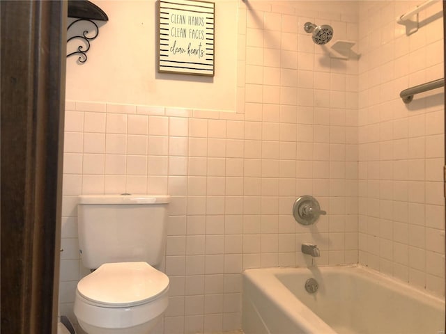 bathroom with tile walls, toilet, and shower / tub combination