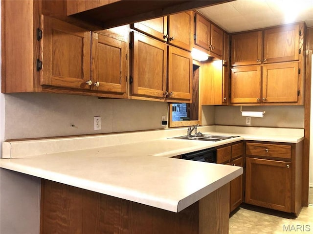 1210 N Prairie, Bloomfield, MO 63825 - kitchen with a sink, brown cabinetry, light countertops, and a peninsula