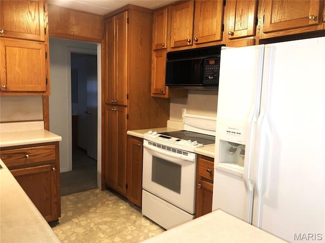 1210 N Prairie, Bloomfield, MO 63825 - kitchen with white appliances, light countertops, brown cabinets, and light flooring