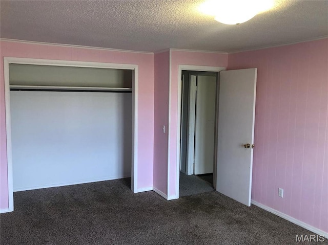 1210 N Prairie, Bloomfield, MO 63825 - unfurnished bedroom featuring dark carpet, ornamental molding, a closet, and a textured ceiling