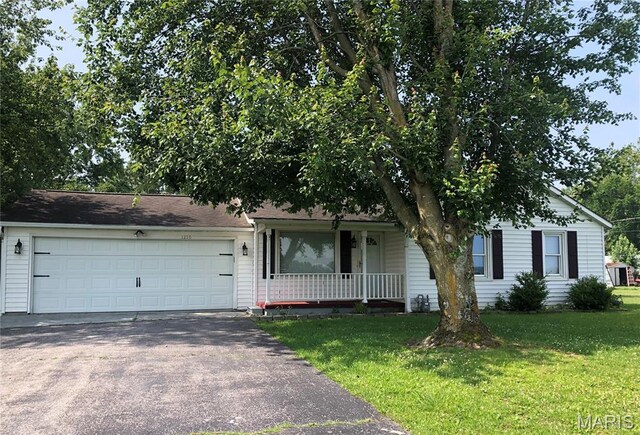 1210 N Prairie, Bloomfield, MO 63825 - view of front of home featuring asphalt driveway, a porch, a front lawn, and a garage
