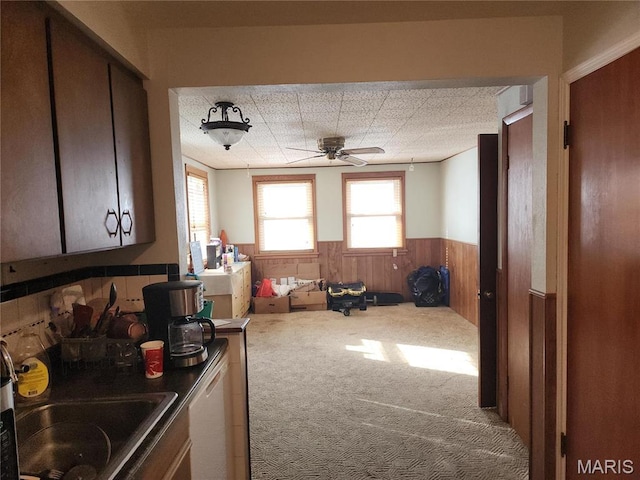 1238 Hoyt Dr, Saint Louis, MO 63137 - kitchen with a wainscoted wall, ceiling fan, carpet floors, and wooden walls