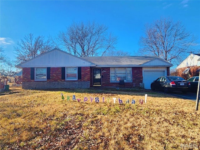 9409 Aetna Dr, Saint Louis, MO 63137 - ranch-style home with an attached garage, a front yard, and brick siding