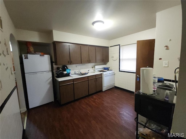 9409 Aetna Dr, Saint Louis, MO 63137 - kitchen with white appliances, dark wood-style flooring, light countertops, dark brown cabinetry, and a sink
