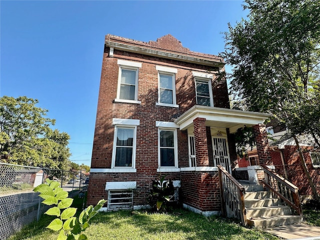 4123 Labadie Ave, Saint Louis, MO 63115 - view of front facade with brick siding, fence, and a porch