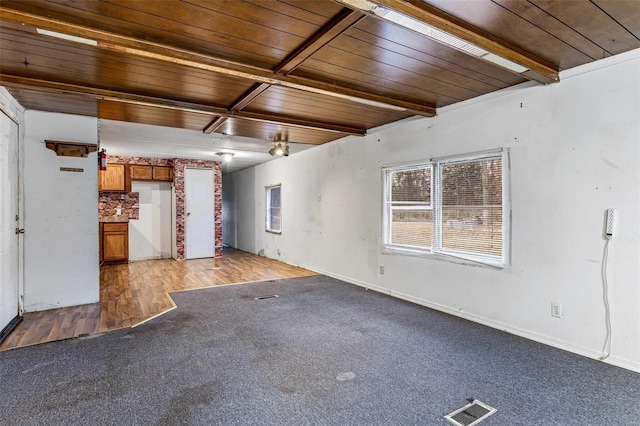 carpeted spare room with wood ceiling and baseboards