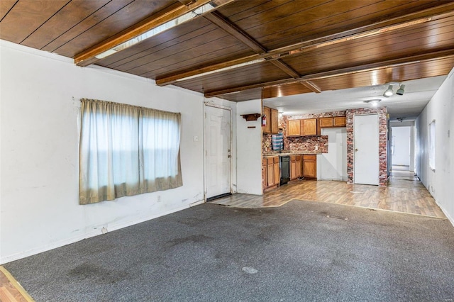 unfurnished living room featuring light carpet, wood ceiling, and baseboards