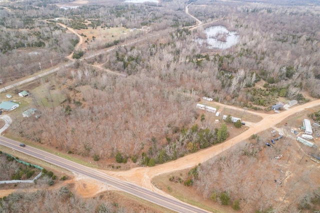 aerial view of property and surrounding area featuring a forest