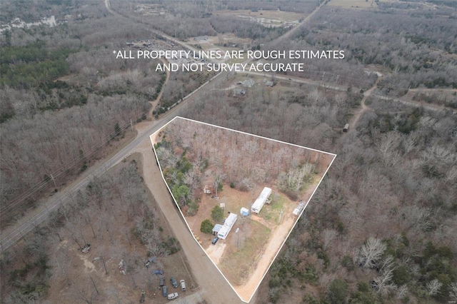 aerial view of property's location with property parcel outlined and a forest