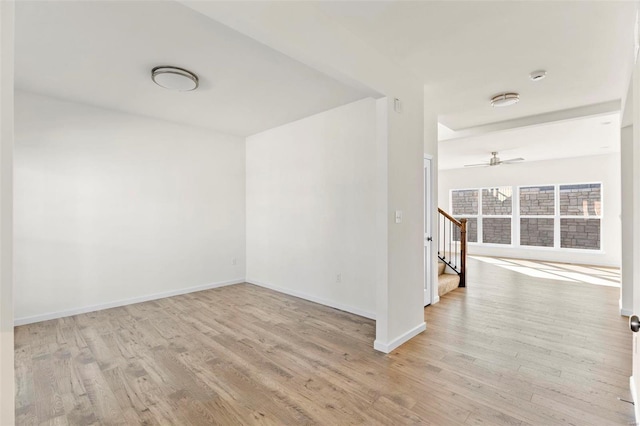 409 Fleming Cir, Wentzville, MO 63385 - spare room with wood finished floors, baseboards, stairway, and a ceiling fan