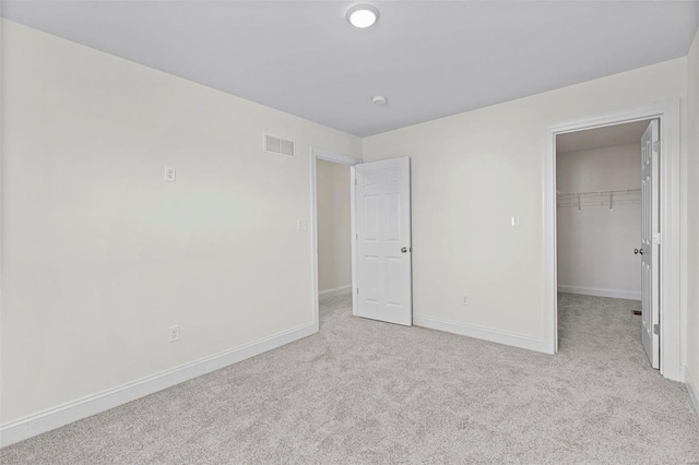 409 Fleming Cir, Wentzville, MO 63385 - unfurnished bedroom featuring carpet flooring, baseboards, a spacious closet, and a closet