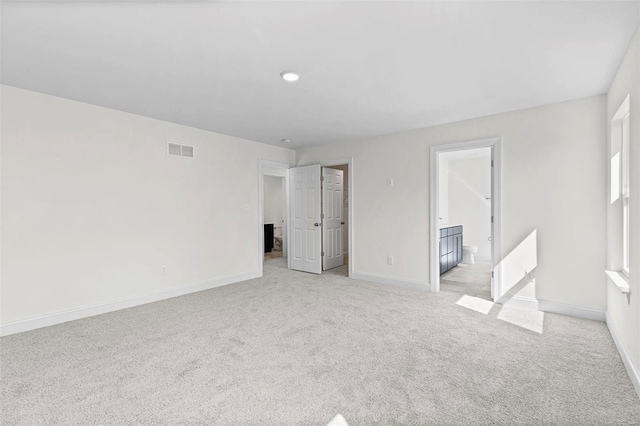 409 Fleming Cir, Wentzville, MO 63385 - unfurnished bedroom with light colored carpet, baseboards, and ensuite bathroom