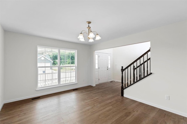 411 Fleming Cir, Wentzville, MO 63385 - entryway featuring a chandelier, stairs, wood finished floors, and baseboards