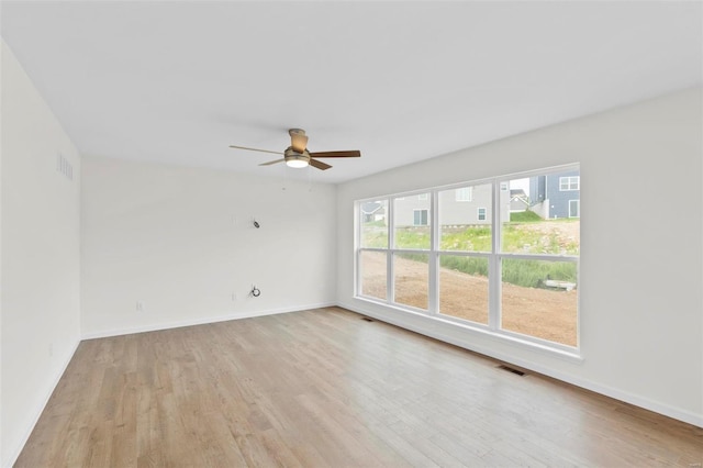 411 Fleming Cir, Wentzville, MO 63385 - spare room with light wood-style flooring, ceiling fan, and baseboards