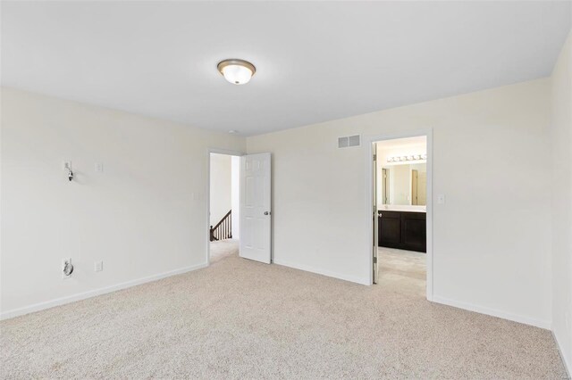 411 Fleming Cir, Wentzville, MO 63385 - unfurnished bedroom featuring light carpet, baseboards, and connected bathroom