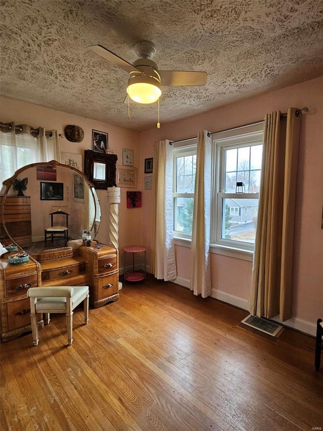 3506 Ohio St, Alton, IL 62002 - home office with light wood-style floors, ceiling fan, a textured ceiling, and baseboards