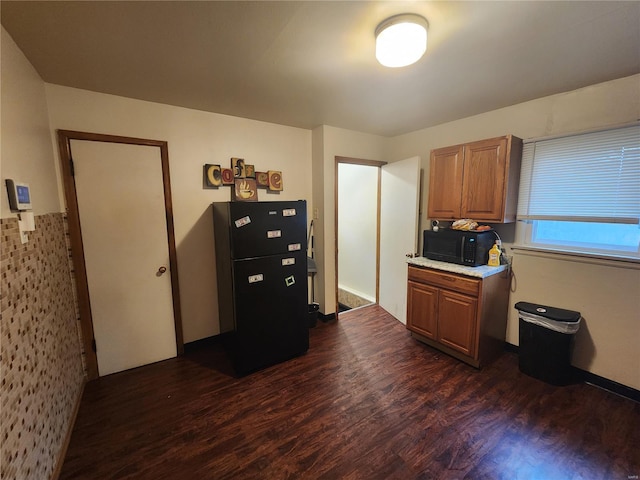 11665 Larimore Rd, Saint Louis, MO 63138 - kitchen featuring black appliances, dark wood finished floors, light countertops, and brown cabinets