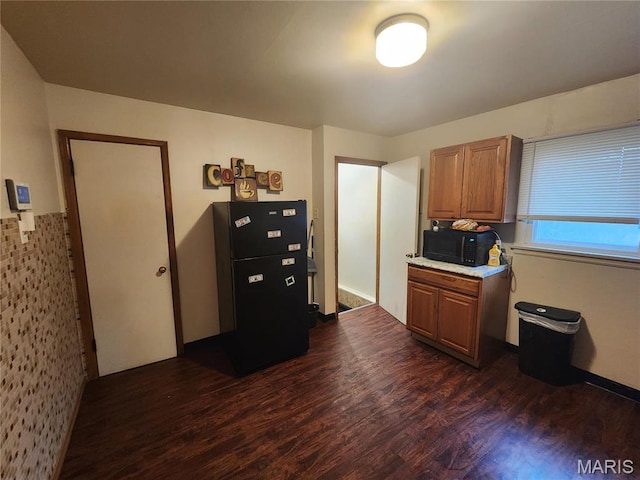 11665 Larimore Rd, Saint Louis, MO 63138 - kitchen with black appliances, dark wood-style flooring, light countertops, and brown cabinets