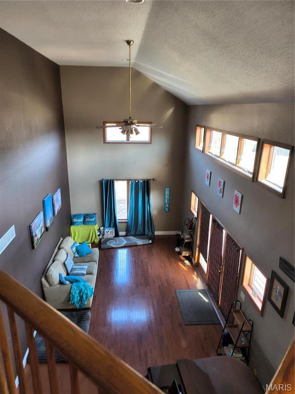 10740 Wilmena Ln, Rolla, MO 65401 - entrance foyer with vaulted ceiling, a ceiling fan, wood finished floors, a textured ceiling, and baseboards