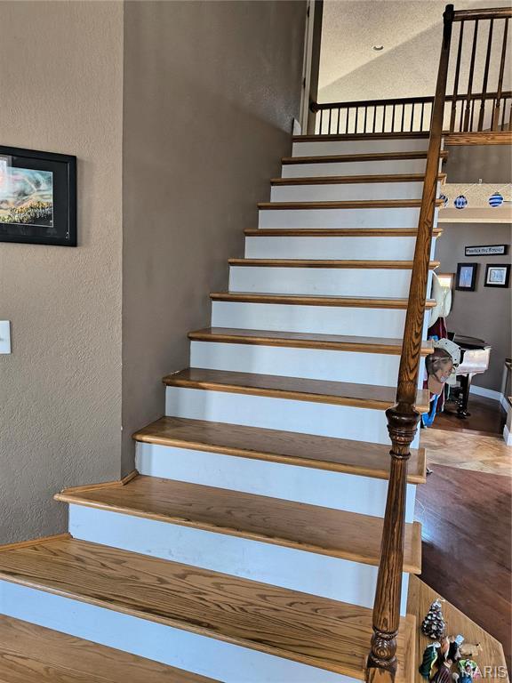 10740 Wilmena Ln, Rolla, MO 65401 - stairway featuring a textured wall and wood finished floors