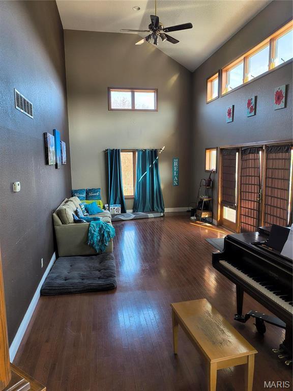 10740 Wilmena Ln, Rolla, MO 65401 - living room featuring hardwood / wood-style floors, ceiling fan, baseboards, and high vaulted ceiling