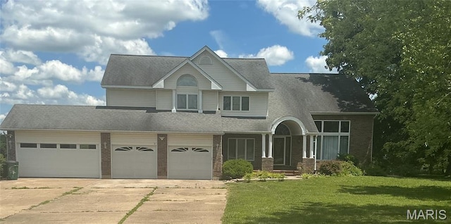 10740 Wilmena Ln, Rolla, MO 65401 - view of front facade featuring concrete driveway, a front yard, a garage, brick siding, and roof with shingles