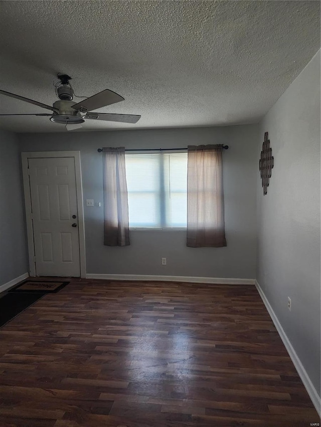 entryway with ceiling fan, wood finished floors, a textured ceiling, and baseboards