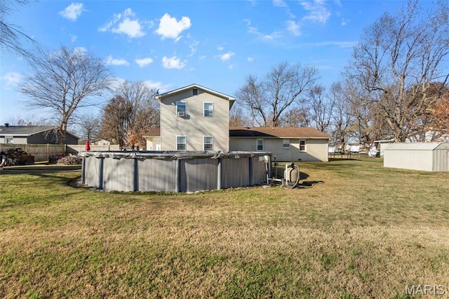 216 Sherrie Dr, Sikeston, MO 63801 - back of property with a lawn and a covered pool