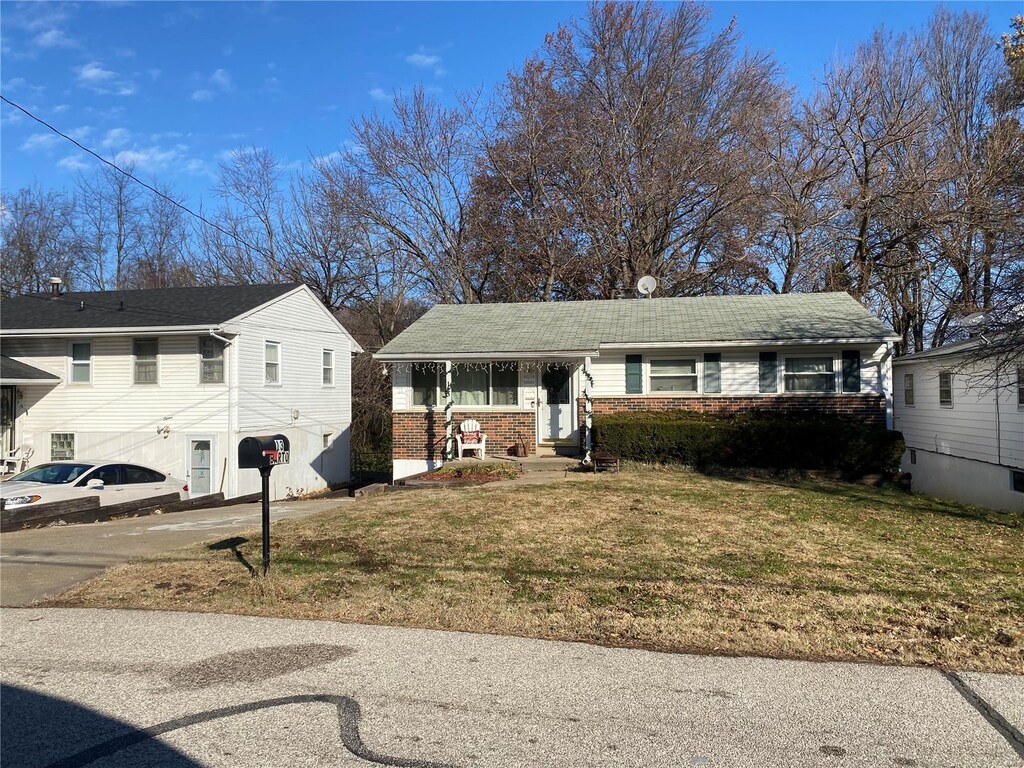13 Barto Dr, Saint Louis, MO 63135 - view of front facade with brick siding and a front lawn
