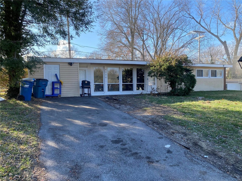 8330 Red Fir Dr, Saint Louis, MO 63134 - view of front of house with driveway and a front lawn