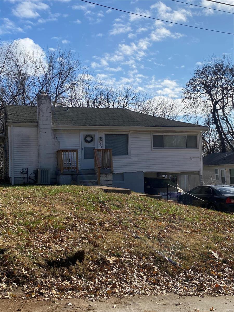 5988 Dupree Ave, Saint Louis, MO 63135 - ranch-style house featuring a chimney, cooling unit, an attached garage, and a porch