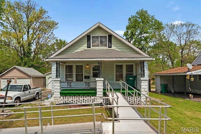 445 Jerome Ln, Cahokia, IL 62206 - shotgun-style home featuring covered porch, a shingled roof, and a detached garage