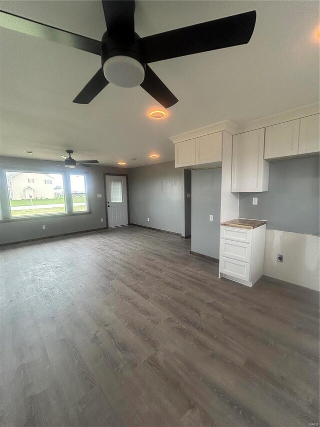 unfurnished living room with ceiling fan and wood finished floors
